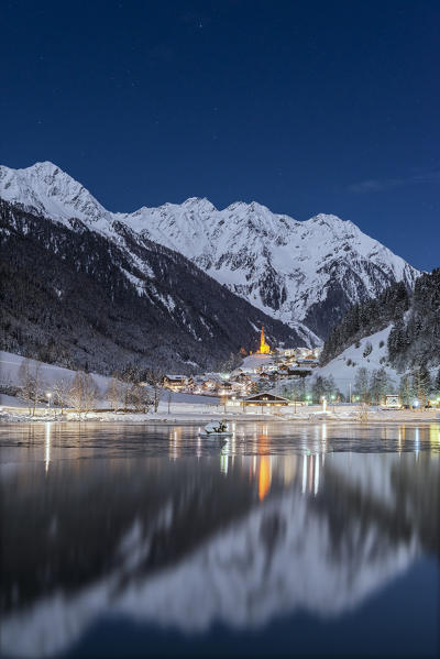 Muehlwald, Bolzano district, South Tyrol, Italy, Europe. The village of Muehlwald is reflected in the Meggima lake