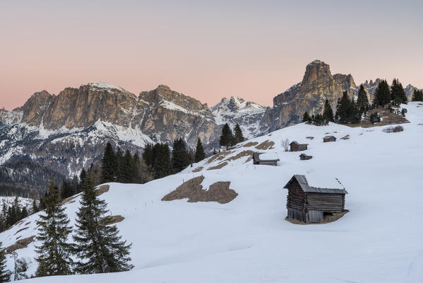 Corvara, Alta Badia, province of Bolzano, South Tyrol, Italy, Europe. Barns in the pastures Pra d'Inzija with the Mount Sassongher in the background