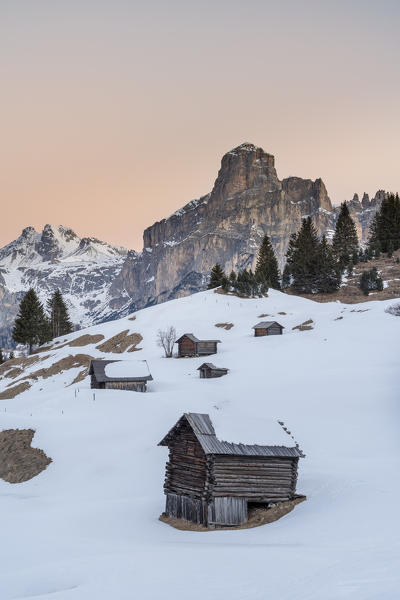 Corvara, Alta Badia, province of Bolzano, South Tyrol, Italy, Europe. Barns in the pastures Pra d'Inzija with the Mount Sassongher in the background