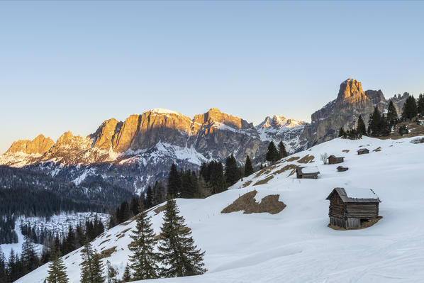 Corvara, Alta Badia, province of Bolzano, South Tyrol, Italy, Europe. Barns in the pastures Pra d'Inzija with the Mount Sassongher in the background