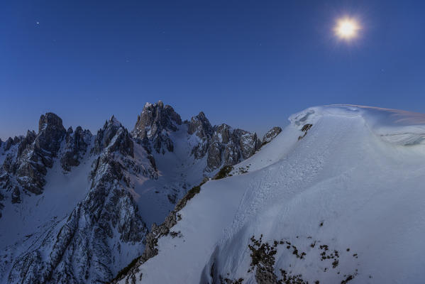 Mount Campedelle, Misurina, Auronzo di Cadore, province of Belluno, Veneto, Italy, Europe. The full moon over the Cadini mountains