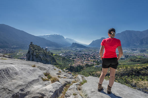 Arco, Trento province, Trentino, Italy, Europe. A Woman admires the panorama of the mountain Colodri, the view extends over the city of Arco to the Lake Garda