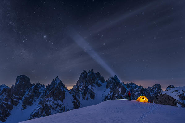 Mount Campedelle, Misurina, Auronzo di Cadore, province of Belluno, Veneto, Italy, Europe. A mountaineer admires the starry sky over the Cadini mountains