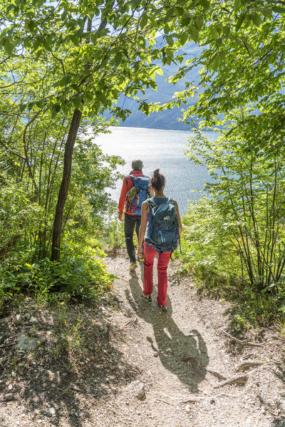 Pregasina, Riva del Garda, Lake Garda, Trento province, Trentino Alto Adige, Italy, Europe. Hiker on a path over the Garda Lake