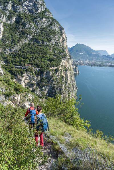 Pregasina, Riva del Garda, Lake Garda, Trento province, Trentino Alto Adige, Italy, Europe. Hiker on a path over the Garda Lake