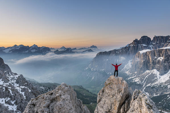 Gran Cir, Gardena Pass, Dolomites, Bolzano district, South Tyrol, Italy, Europe. A mountaineer admires the sunrise at the summit of the Gran Cir (MR)