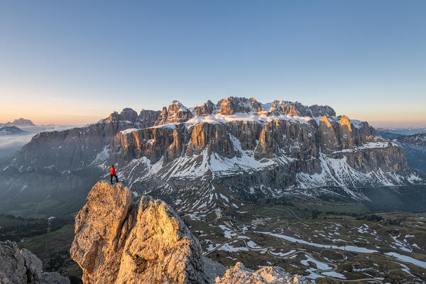 Gran Cir, Gardena Pass, Dolomites, Bolzano district, South Tyrol, Italy, Europe. A mountaineer admires the sunrise at the summit of the Gran Cir (MR)