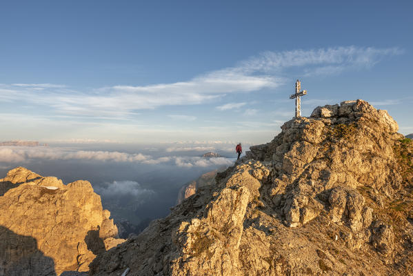 Gran Cir, Gardena Pass, Dolomites, Bolzano district, South Tyrol, Italy, Europe. A mountaineer climb the summit of the Gran Cir at sunrise (MR)