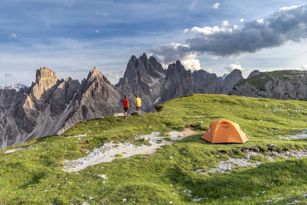 Mount Campedelle, Misurina, Auronzo di Cadore, province of Belluno, Veneto, Italy, Europe. Two mountaineers admires the  sunset at the Cadini di Misurina mountains (MR)