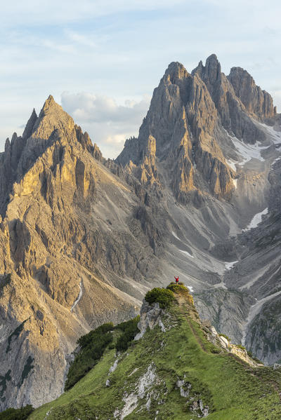 Mount Campedelle, Misurina, Auronzo di Cadore, province of Belluno, Veneto, Italy, Europe. A mountaineer admires the sunset in the Cadini di Misurina mountains