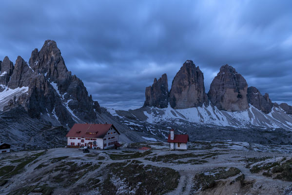 Sesto / Sexten, province of Bolzano, Dolomites, South Tyrol, Italy. Blue hour at the Tre Cime di Lavaredo, Mount Paterno and refuge Locatelli