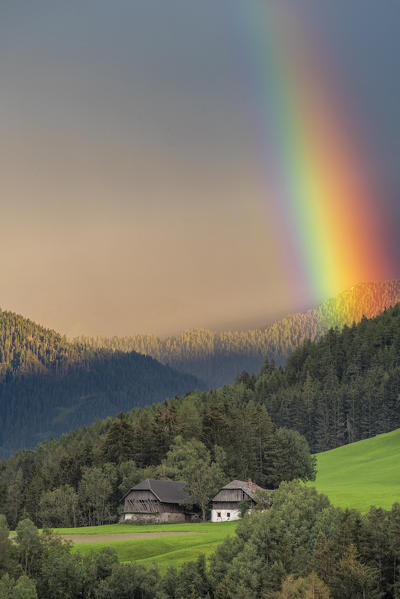 Valdaora/ Olang, Bolzano province, South Tyrol, Italy. 
A rainbow over an abandoned farm