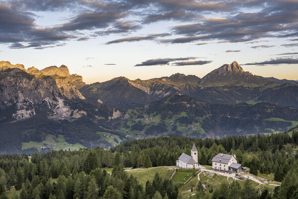 Alta Badia, Bolzano province, South Tyrol, Italy, Europe.  The pilgrimage church La Crusc and the La Crusc refuge at sunrise