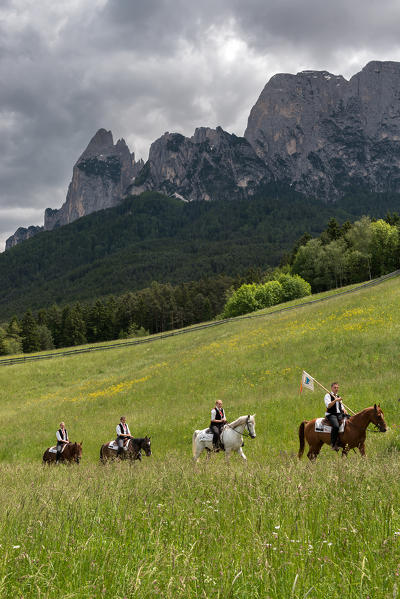 Fie, South Tyrol, Italy. The riders are on their way to the third tournament at Lake Fie. In the background the Mount Sciliar