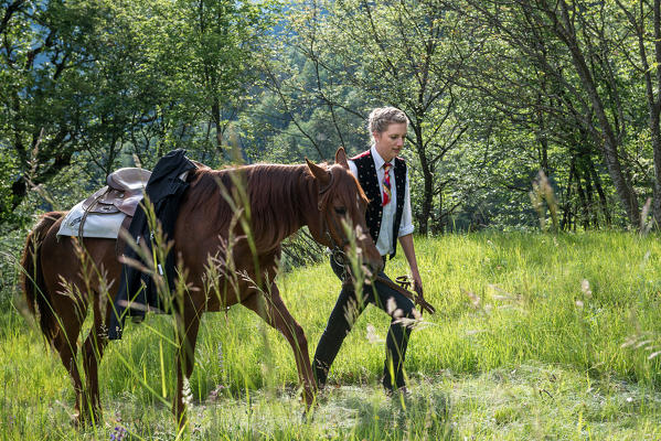 Castelrotto, South Tyrol, Italy. Rider and horse on the way to the first tournament