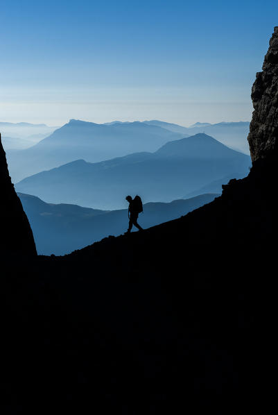 Brenta, Trentino, Italy. Early morning this hiker is on the Sentiero delle Bocchette Alte