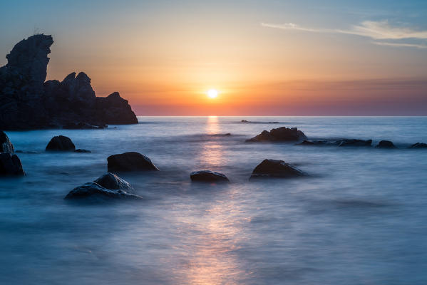 Zambrone, Calabria, Italy. Sunset on the beach of Capo Cozzo in Calabria with the Lion Rock