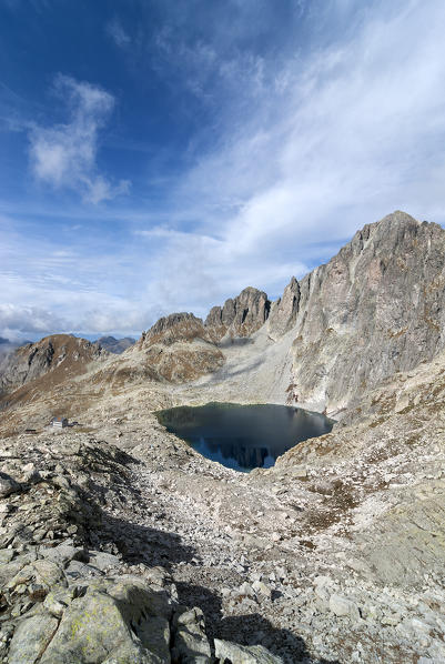 Cima d'Asta, Trentino, Italy. The Cima d'Asta (2847m). Under the rockwall the lake of Cima d'Asta and the refuge Ottone Brentari