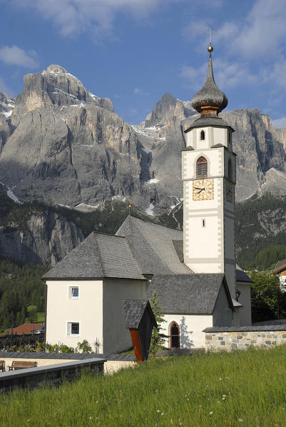 Colfosco, Dolomites, South Tyrol, Italy. The church San Vigilio in Colfosco with the Sella mountains