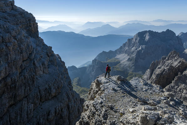 Brenta Dolomites, Trentino, Italy. Mountaineer admiring the view from the via ferrata Bocchette Alte