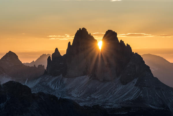 Picco di Vallandro, Prato Piazza, Dolomites, South Tyrol, Italy. The sun rises exactly in between the crags of the Tre Cime di Lavaredo. This effect occurs only few days per year, exactly during winter solstice days