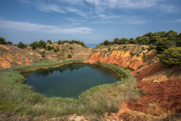 Otranto, province of Lecce, Salento, Apulia, Italy. Abandonet Bauxite Mine with green Lake