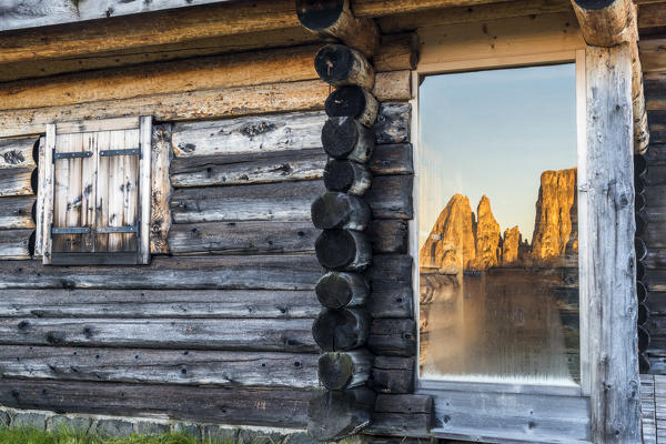 Alpe di Siusi/Seiser Alm, Dolomites, South Tyrol, Italy. Sunrise on the Alpe di Siusi/Seiser Alm. The peaks are reflected in a glass pane