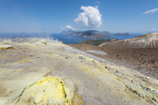 Volcano, Messina district, Sicily, Italy, Europe. Sulfur fumaroles on the crater rim of Vulcano. In the background the islands of Filicudi, Salina, Lipari and Panarea