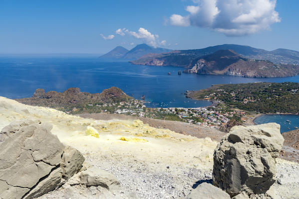 Volcano, Messina district, Sicily, Italy, Europe. Sulfur fumaroles on the crater rim of Vulcano. In the background the islands of Lipari and Salina