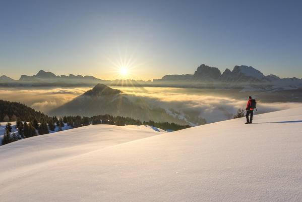 Alpe di Siusi/Seiser Alm, Dolomites, South Tyrol, Italy. Sunrise on the plateau of Bullaccia/Puflatsch. In the background the peaks of the Odle, Sella and Sassolungo