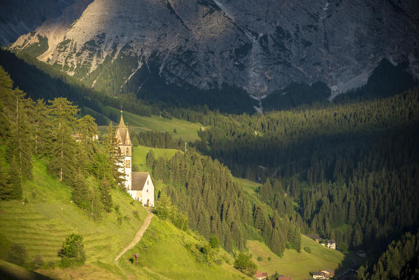 La Valle / Wengen, Alta Badia, Bolzano province, South Tyrol, Italy. The St. Barbara chapel at sunset