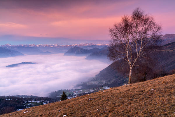 Iseo lake under the fog in Autumn season at sunset, Lombardy district, Brescia province, Italy, Europe