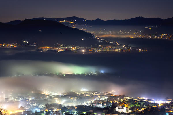 Iseo and Iseo lake under the fog. Brescia province, Lombardy district, Italy, Europe.