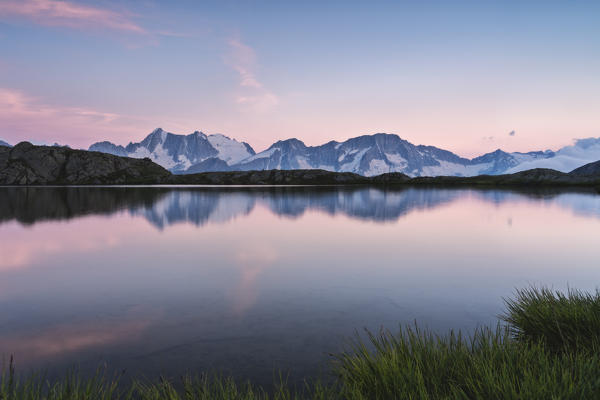 Presanella group at sunset from Strino lake in Trentino Alto Adige, Italy