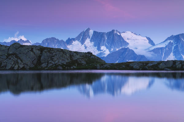 Presanella group at sunset from Strino lake in Trentino Alto Adige, Italy