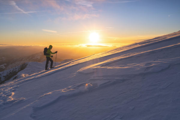 Hiker in Brescia prealpi at dawn, Monte Guglielmo, Brescia provinc, Lombardy District, Italy.