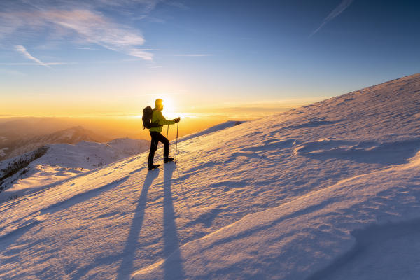 Hiker in Brescia prealpi at dawn, Monte Guglielmo, Brescia provinc, Lombardy District, Italy.