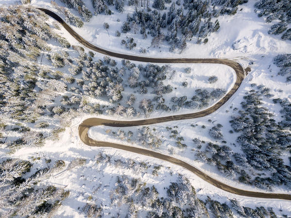 Snowy road aerial view, Passo Delle Erbe ,Funes Valley, South Tyrol, Italy, Europe