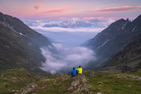 Admiring sunset over the fog in Canè valley, Vallecamonica, Brescia province, Italy.