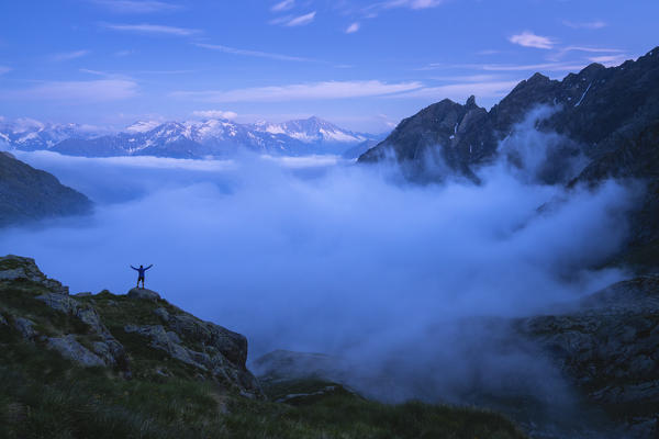 Blue hour over the fog in Canè valley, Vallecamonica, Brescia province, Italy.