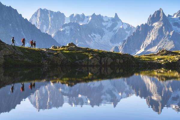 Hikers at Lac des Chèserys in Chamonix Valley, Chamonix Mont Blanc, Haute-Savoie, France