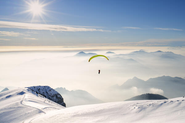 Paragliding in Brescia prealpi in winter season, Brescia province, Lombardy district, Italy, Europe.