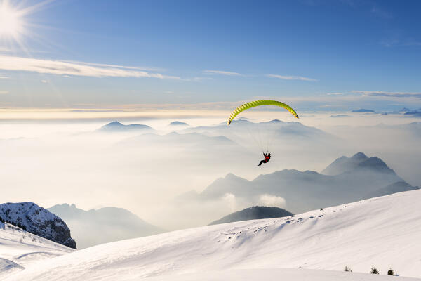 Paragliding in Brescia prealpi in winter season, Brescia province, Lombardy district, Italy, Europe.