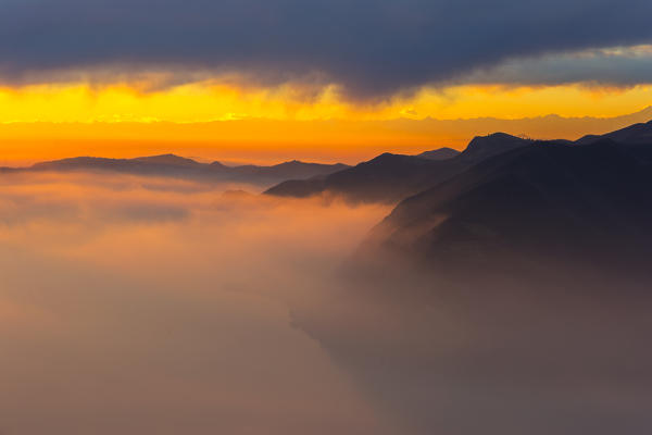 Fog at sunset on Lake Iseo. The winter sunsets always offer many emotions, Lake Iseo in the province of Brescia