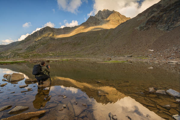 Photographer in action at Gaviapass, province of Brescia, Italy.