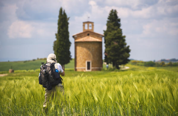 Europe, Italy photographer at the chapel Vitaleta, province of Siena, Tuscany.