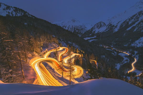 Car lights at night, Maloja Pass, Engadin, canton of Graubunden, Switzerland