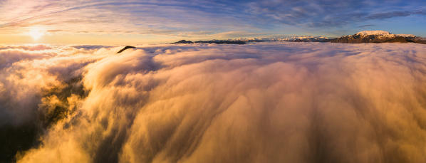 Sunset over the fog, Lombardy district, Brescia province, Italy