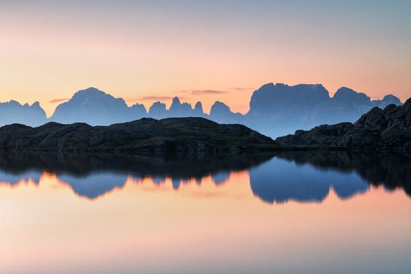 Brenta dolomites at dawn reflected in Lago Nero di Cornisello, Trentino Alto Adige, Italy.