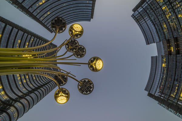 Gae Aulenti Square with iconic streetlights. Milan, Lombardy, Italy.